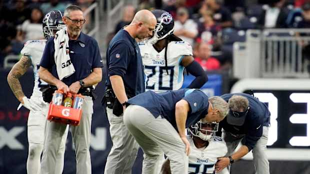 Trainers check on Tennessee Titans cornerback Kristian Fulton (26) after he was injured on a play during the fourth quarter at NRG Stadium Sunday, Jan. 9, 2022 in Houston, Texas.
